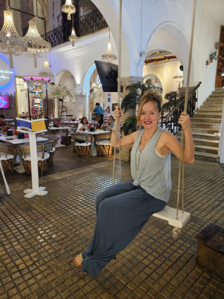 A photo of me, Susanne Wilson, in a swing located into a restaurant in Merida Mexico. 