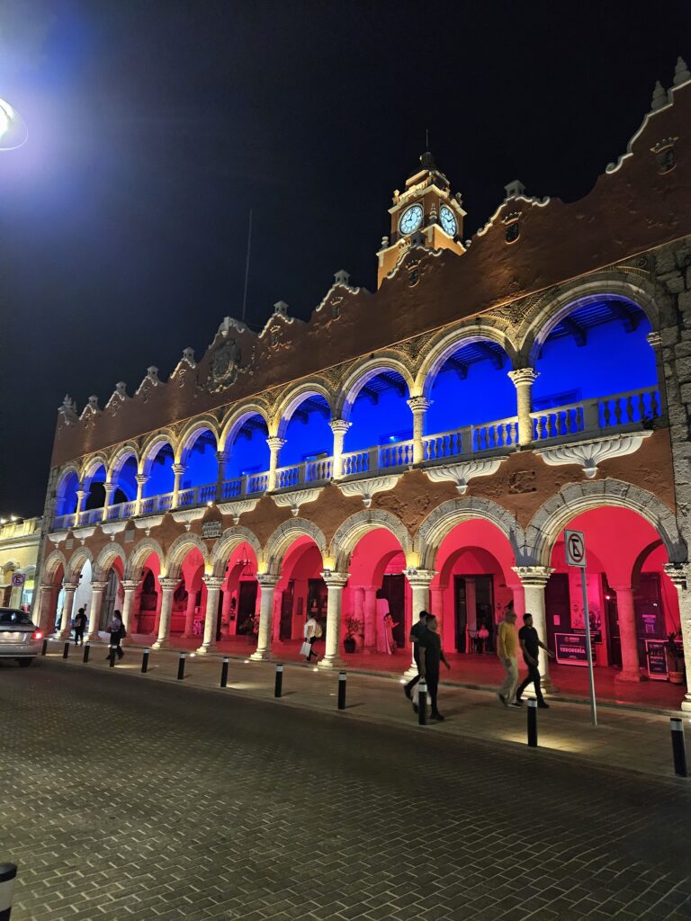 Grand Plaza Buildings lit up at night in Red and Blue in Merida, Mexico