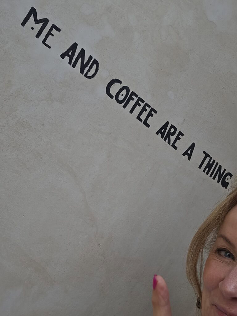 Coffee cafe wall with words, "Me and Coffee Are a Thing."