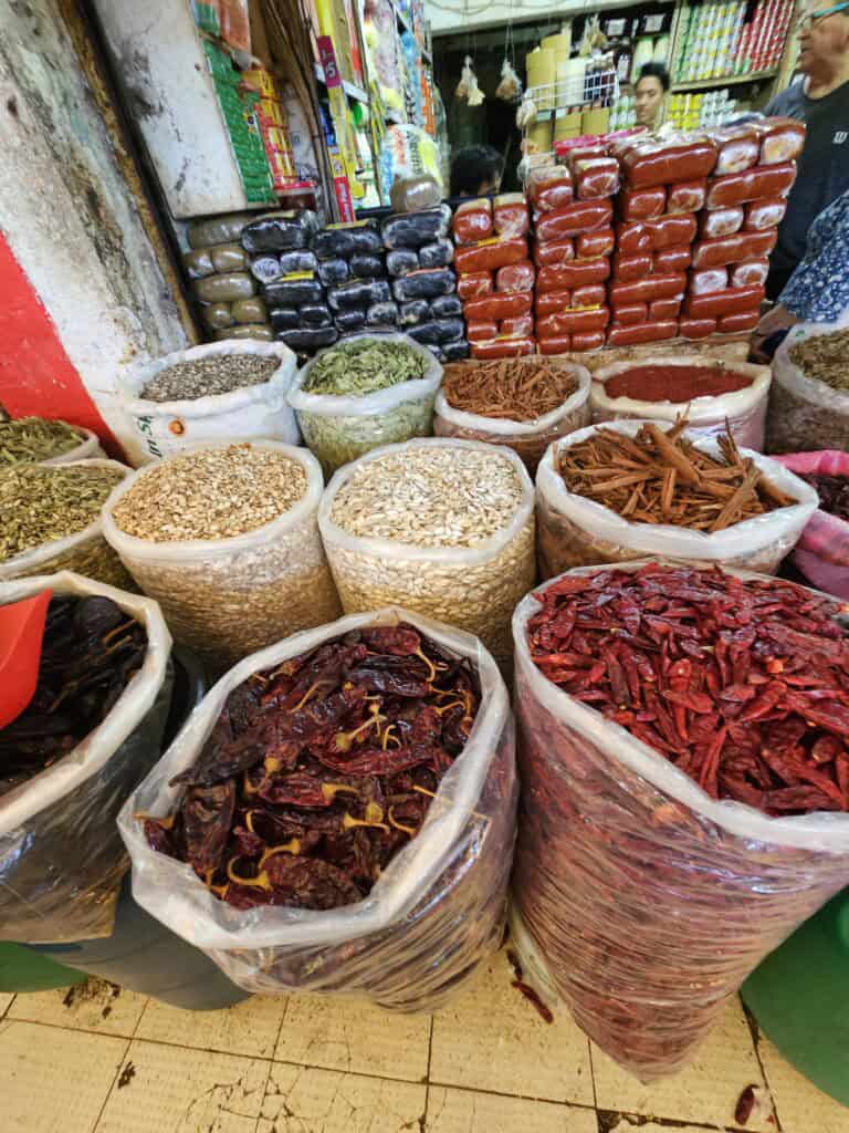 Bags of vegetables, and peppers in the market in Merida Mexico