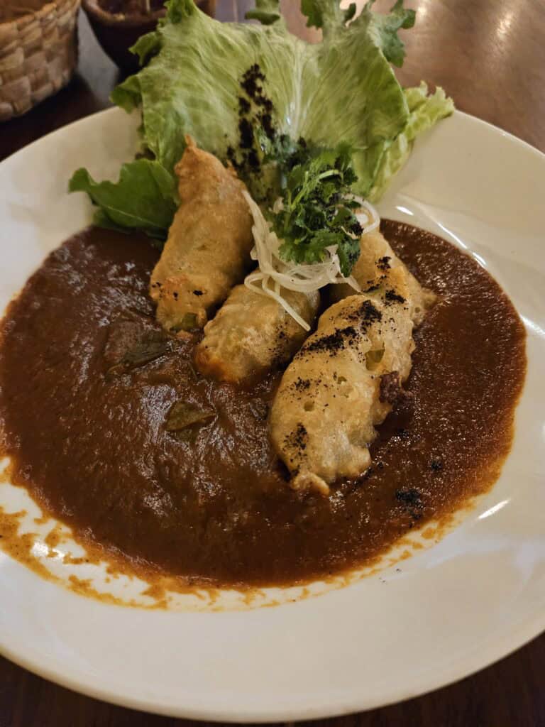 Fusion dish Flores En Amarillo which was fried zucchini blossoms stuffed with herbs, oaxaca cheese over mole at Apoala Restaurant in Merida, Mexico