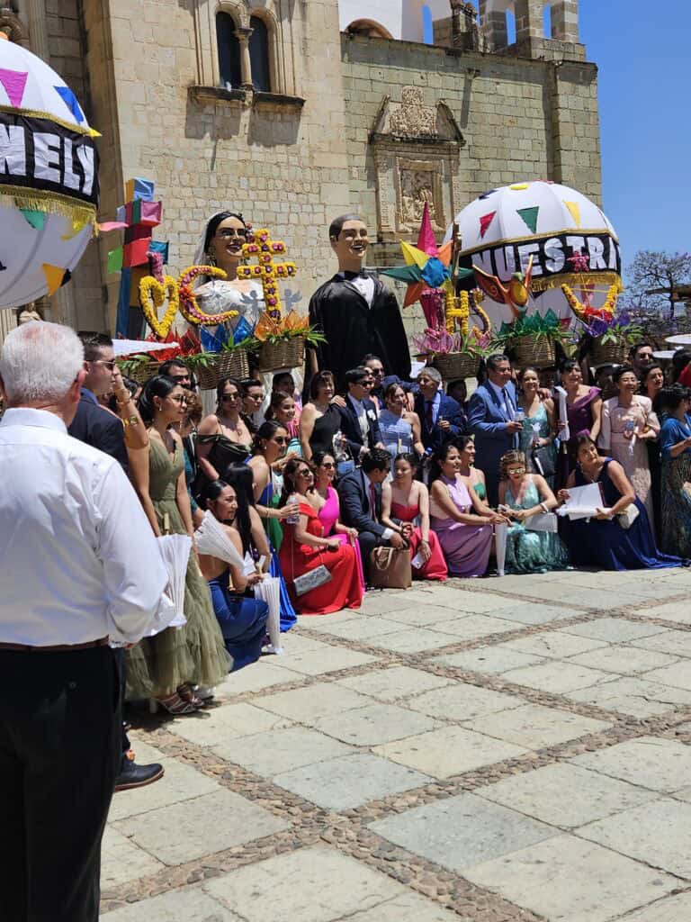Large wedding gathering outside of the famous Templo de Santo Domingo de Guzman in Oaxaca Mexico