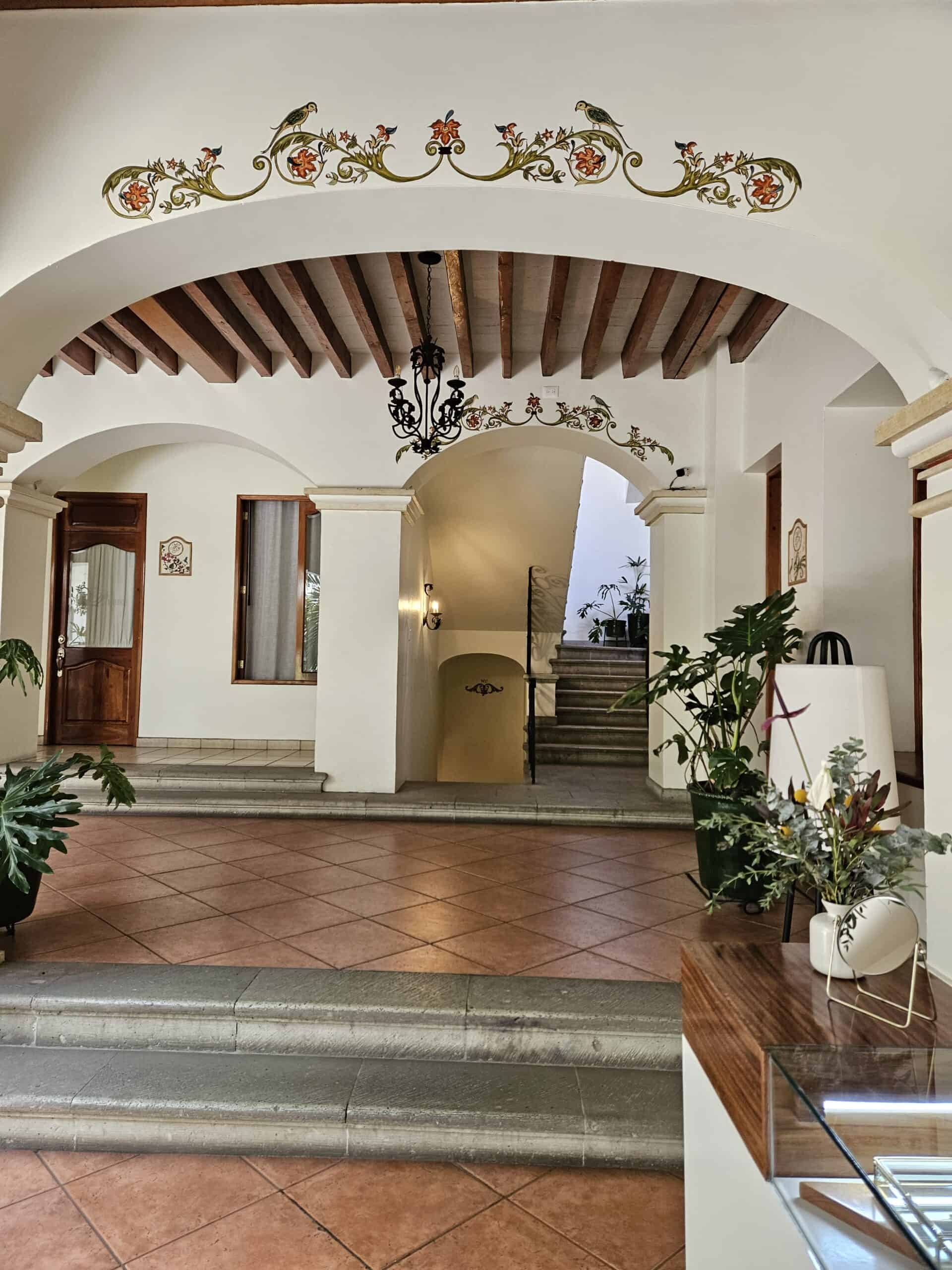 Hotel entry arched doorways, cream walls and terra cotta floors in Oaxaca Mexico
