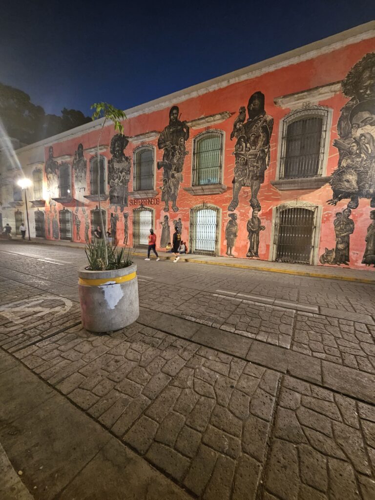 Murals on the wall of a building on the Calle Macedonio Alcala in Oaxaca Mexico