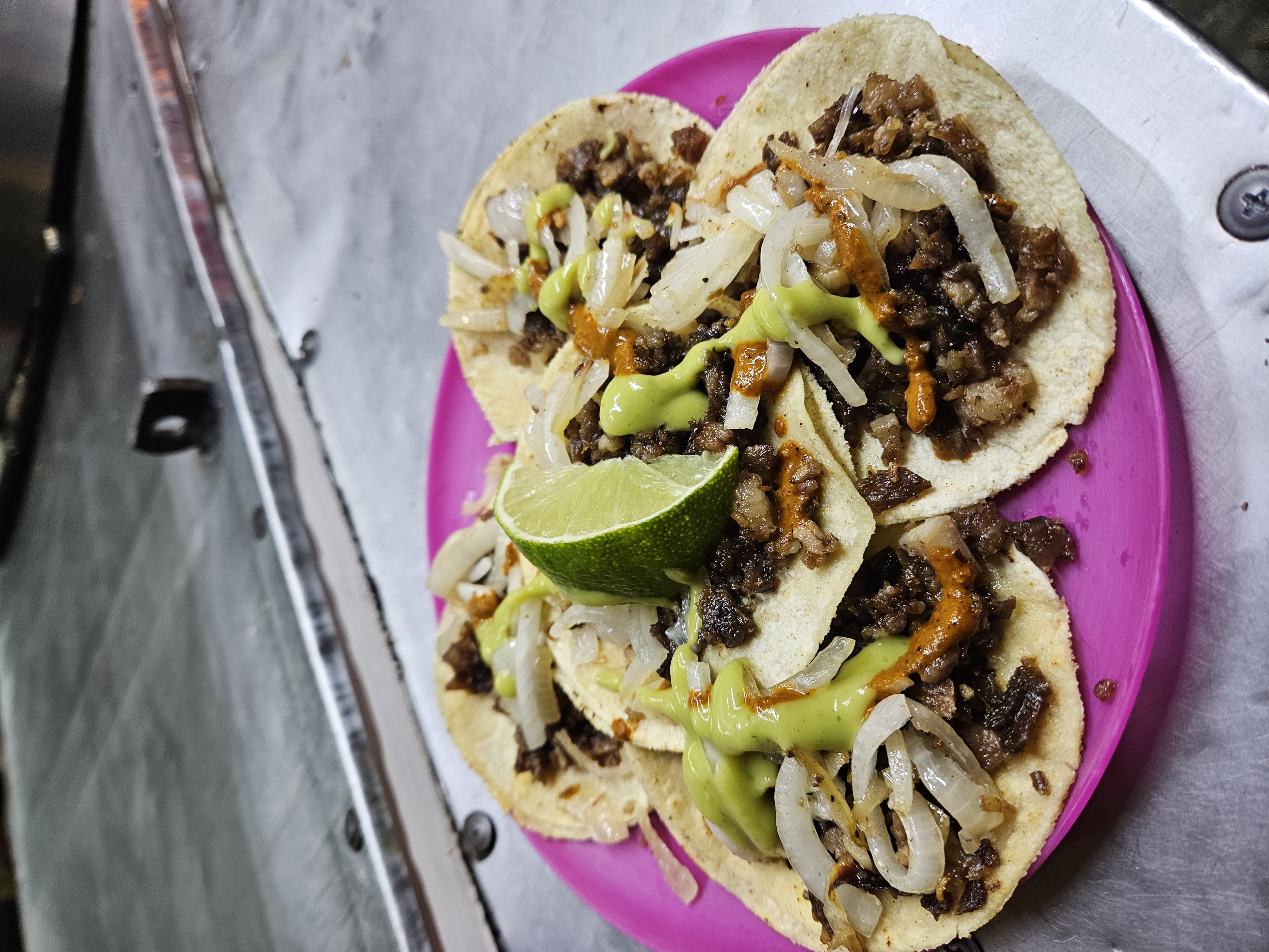 Tacos (five) with onions and a slice of lime from a street food vendor in Oaxaca Mexico