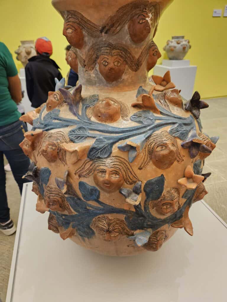 Large piece of pottery with vines and small human faces found in Oaxaca Mexico