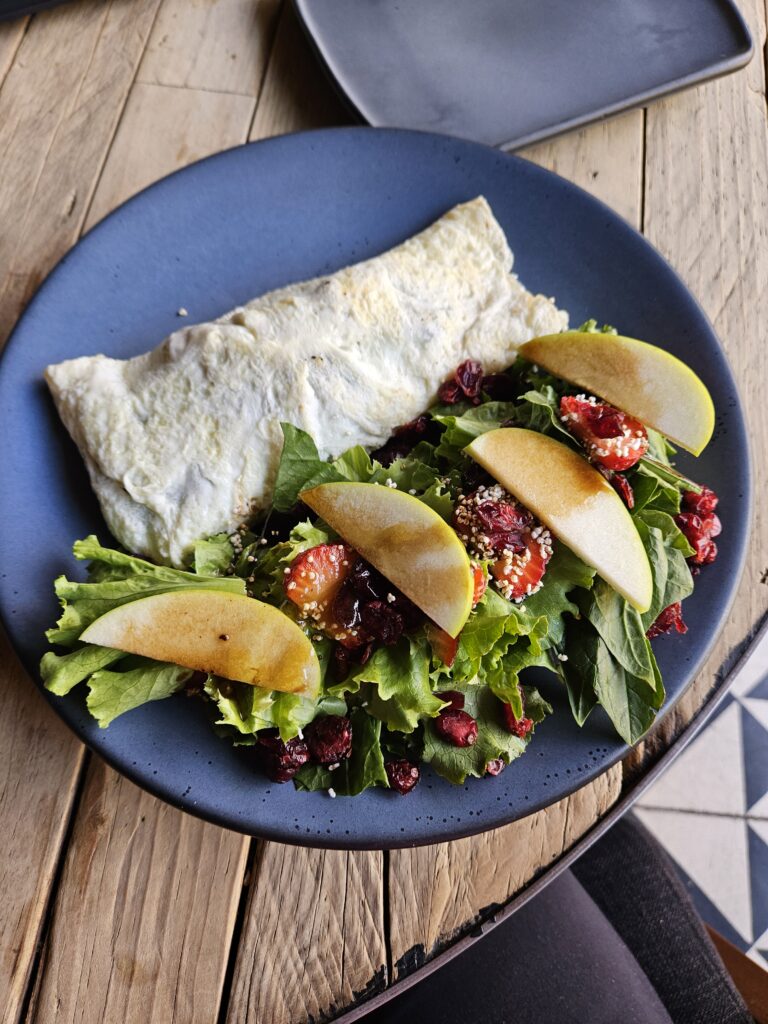 Burrito with a side salad topped with slices of apple in Oaxaca Mexico