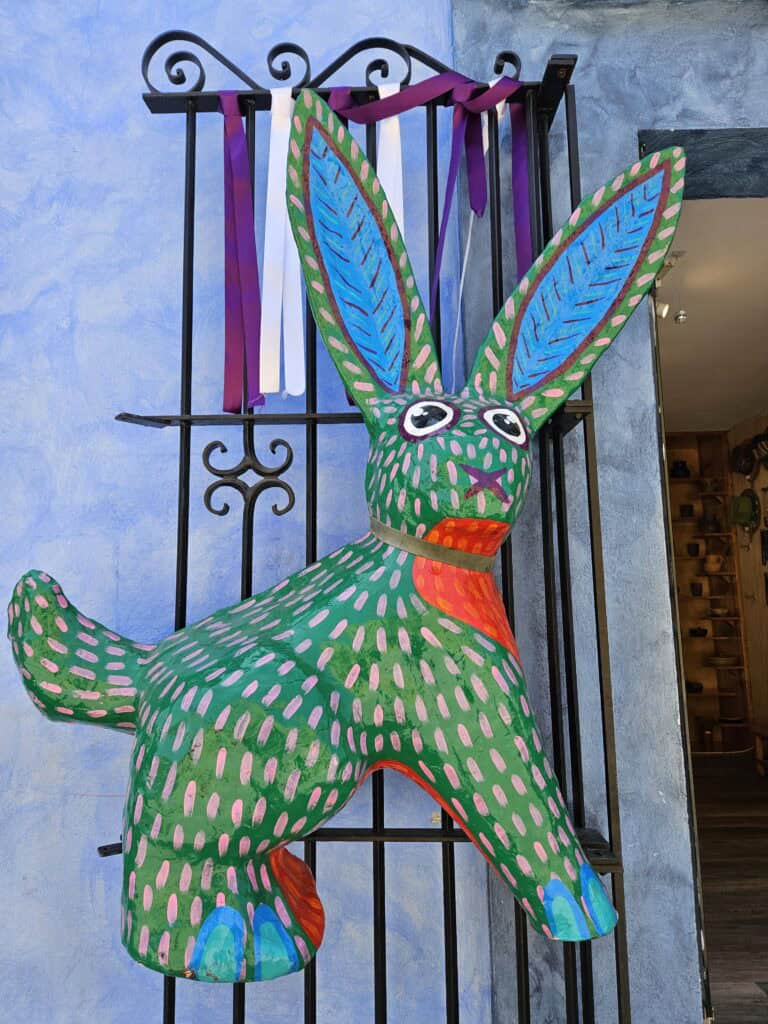 Rabbit alebrijes painted green, blue and red found outside a shop in Oaxaca Mexico