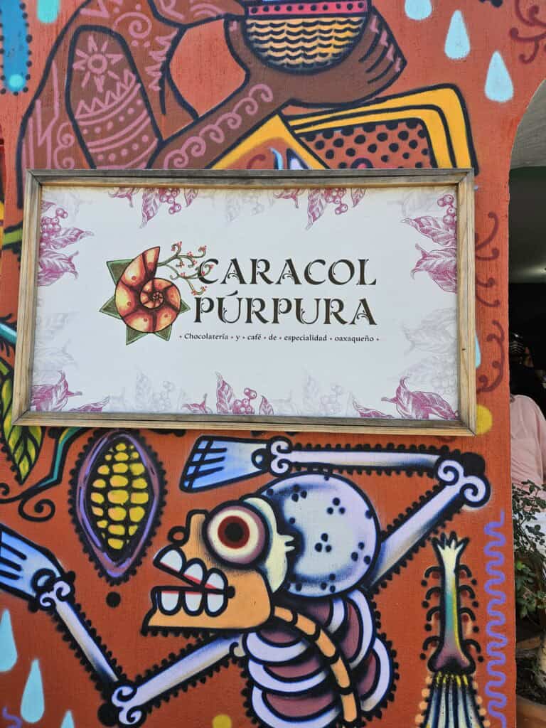 Sign for Caracol Púrpura out side of the cafe in Oaxaca Mexico