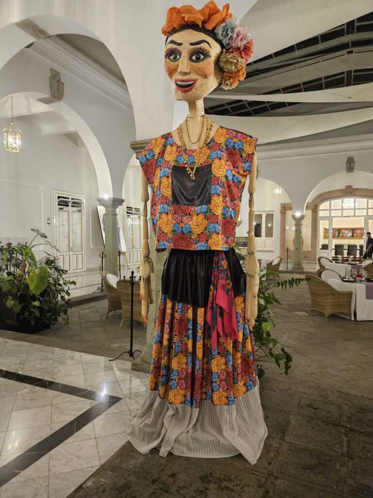 A female Mojigangas or giant puppet dressed traditionally in the lounge of the hotel on the way to Mi Cielo rooftop bar in Oaxaca Mexico