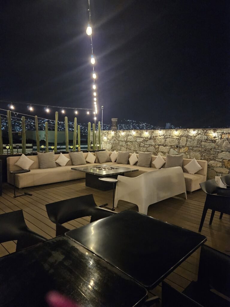 Mi Cielo rooftop bar, white sectional sofa, lights and pillows for lounging in Oaxaca Mexico