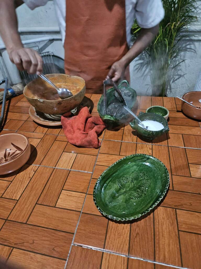 Chef preparing the Caldo de Piedra or stone soup in Oaxaca Mexico