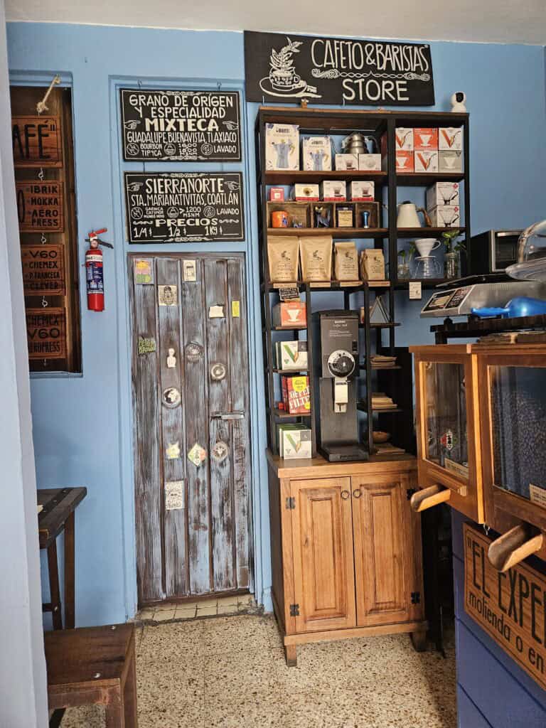 Display wall with coffees and products inside Cafeto & Baristas in Oaxaca Mexico