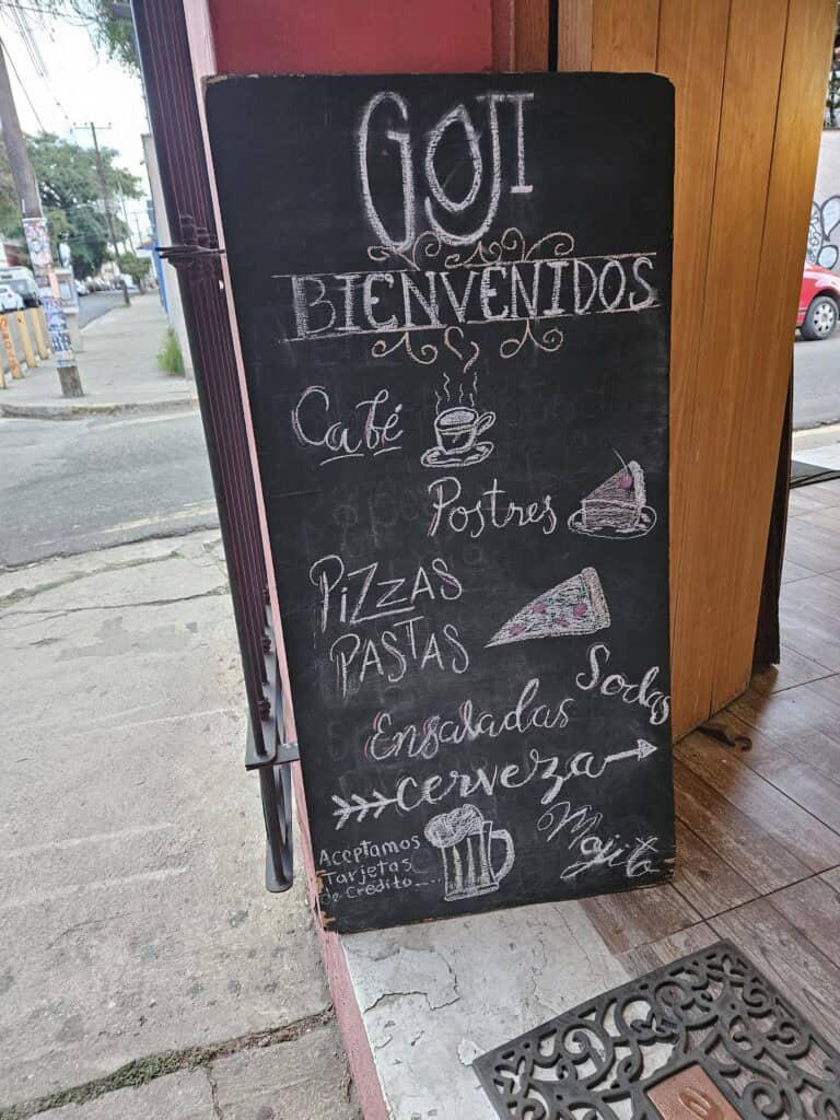 Welcome chalkboard sign for Goji Cafe list some of their menu items.