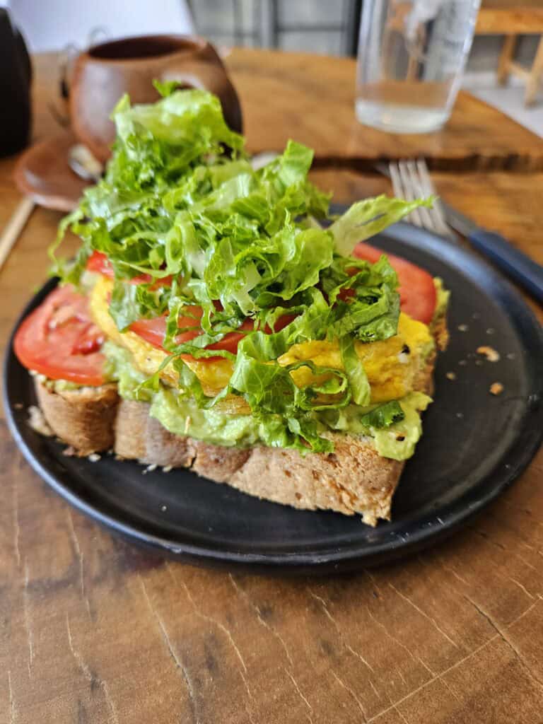 Avocado toast on a black plate