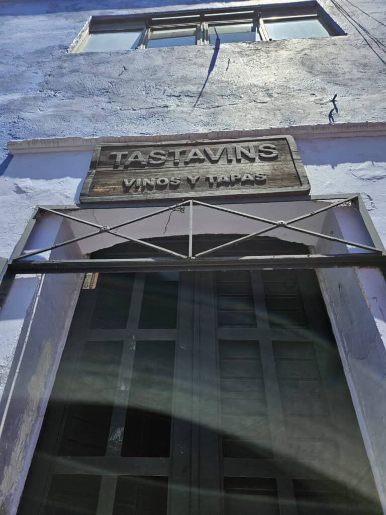 Outdoor sign for Tastavins vinos and tapas bar in Oaxaca Mexico
