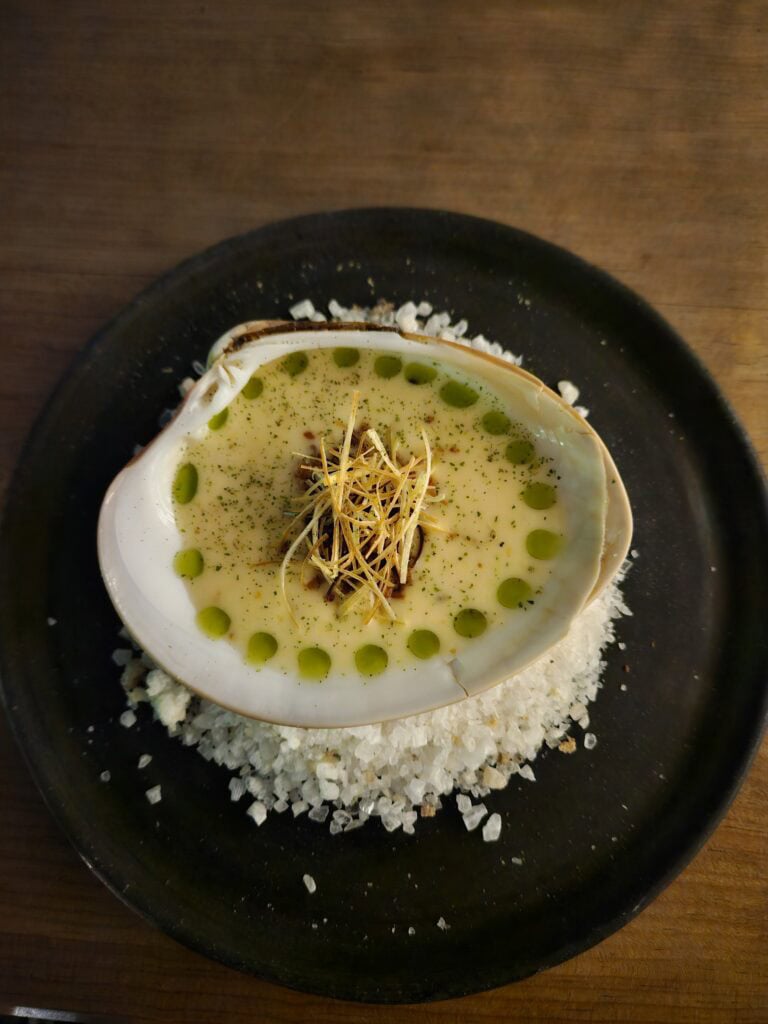 Oyster shell with soup as part of the tasting menu at Nois Restaurant in Oaxaca Mexico