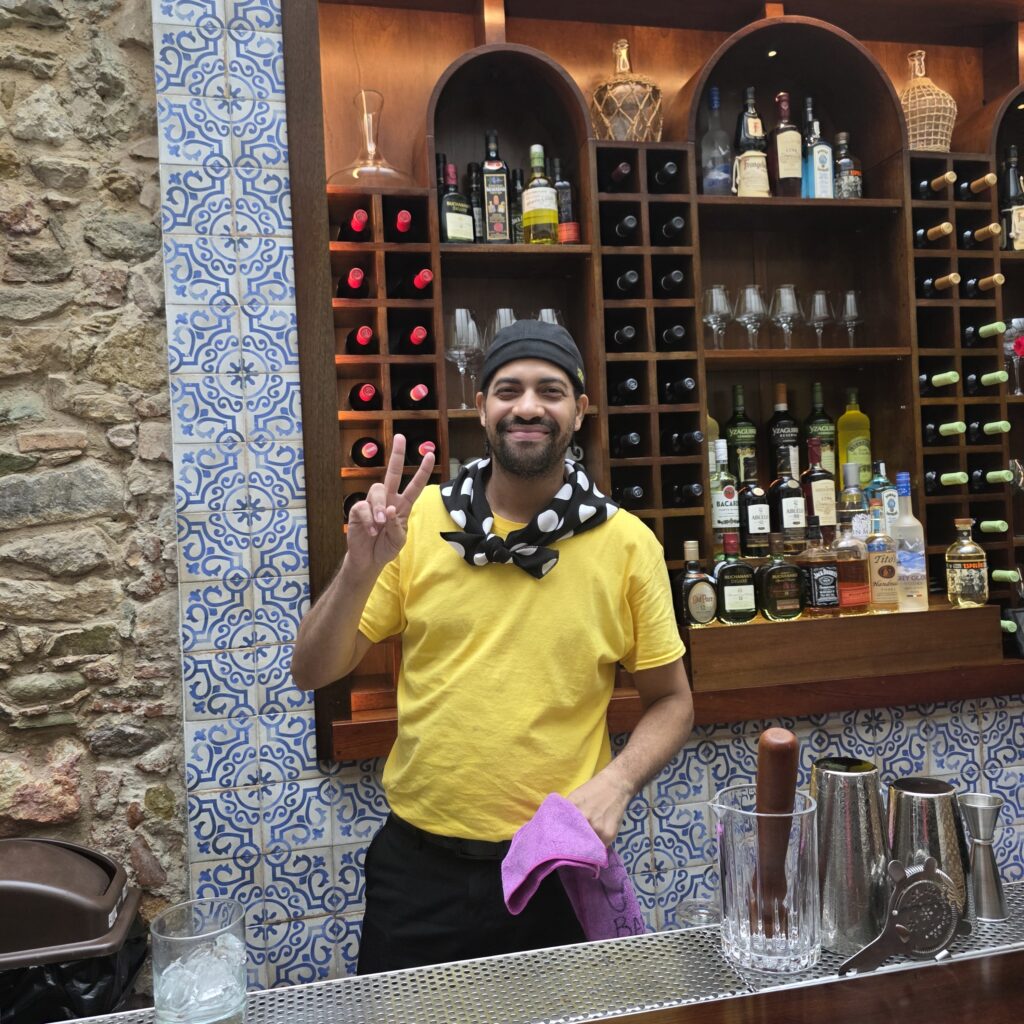 Waiter dressed in yellow shirt, bandana and head scarf in Tasca La Candelaria tapa restaurant in Casco Viejo Panama