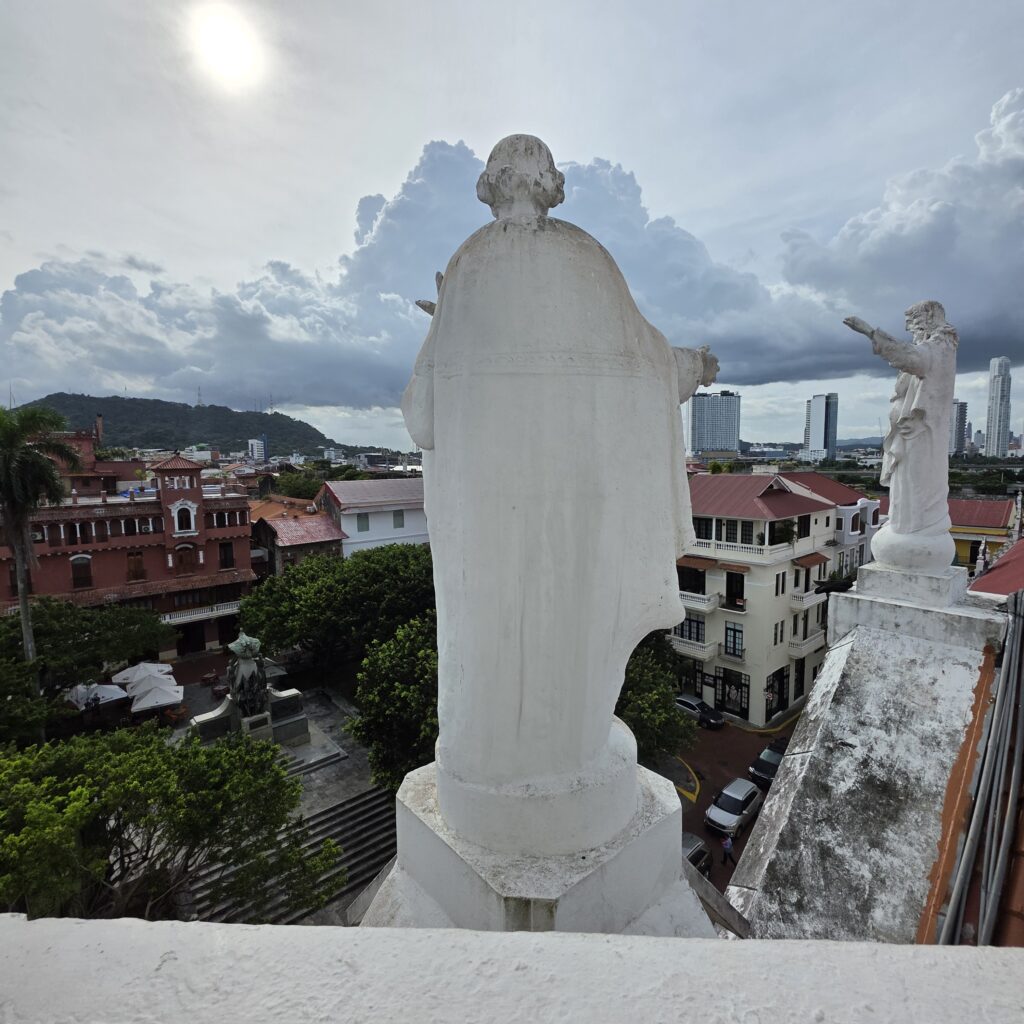 View of Casco Viejo from a church tower with a white statue in the foreground