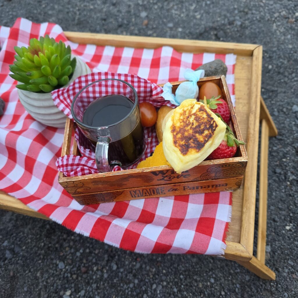 Breakfast on a tray with a red and white checkered placemat at the top of Volcan Baru in Panama